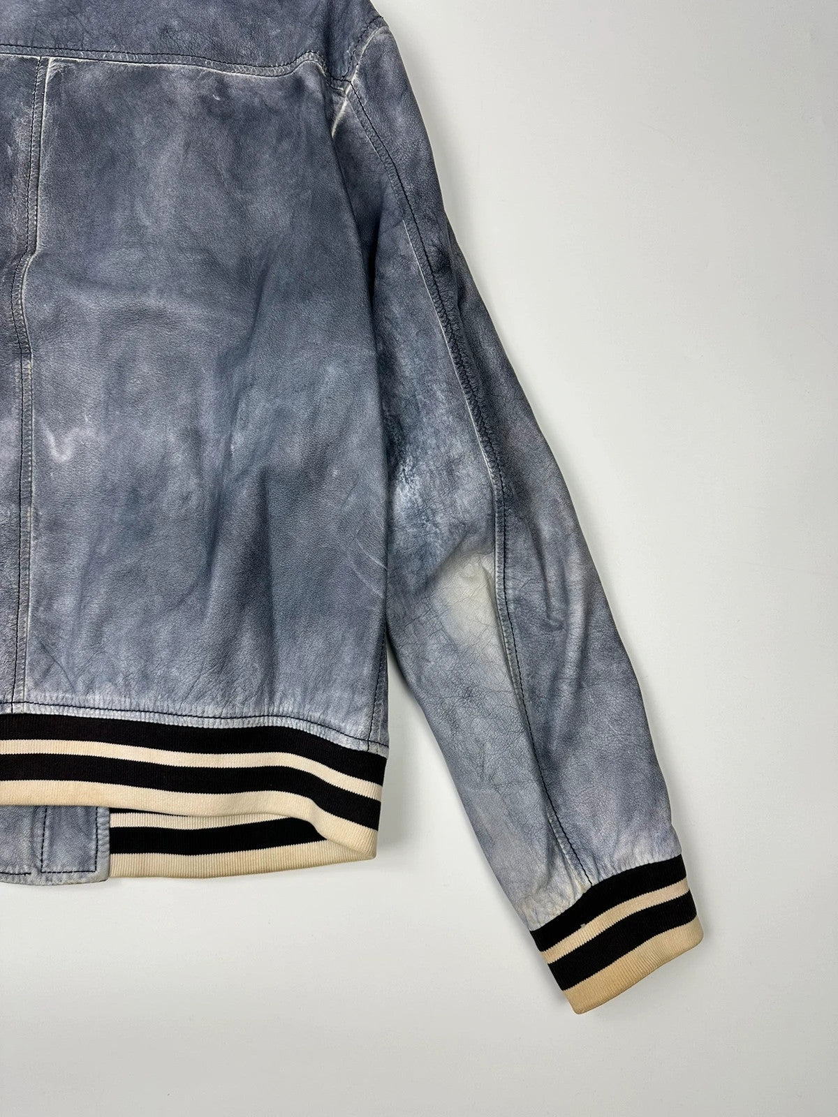 Armani blue and purple bomber jacket, eroded leather, vintage 2000s style.