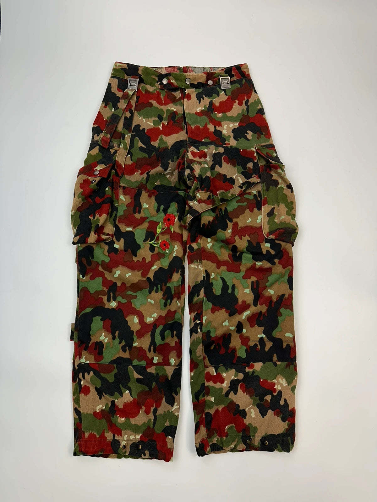 Dolce & Gabbana green camo wide-leg trousers with reworked straps and military pattern.
