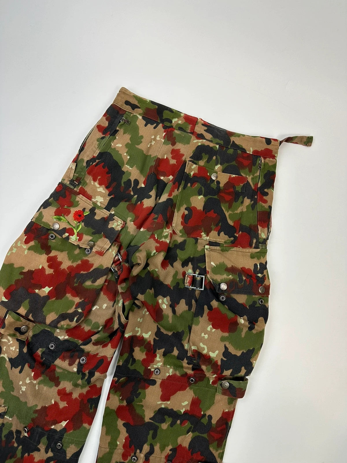 Dolce & Gabbana green camo wide-leg trousers with reworked straps and military pattern.