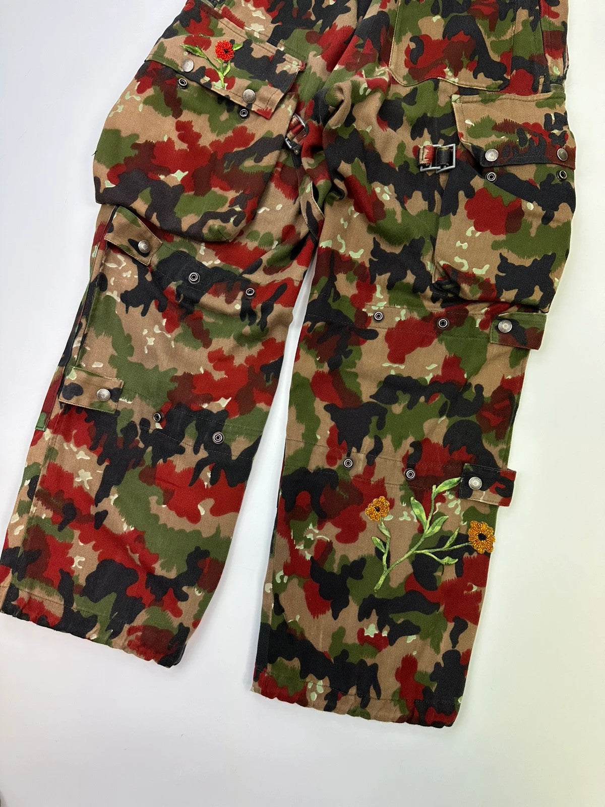 Dolce & Gabbana green camo wide-leg trousers with reworked straps and military pattern.