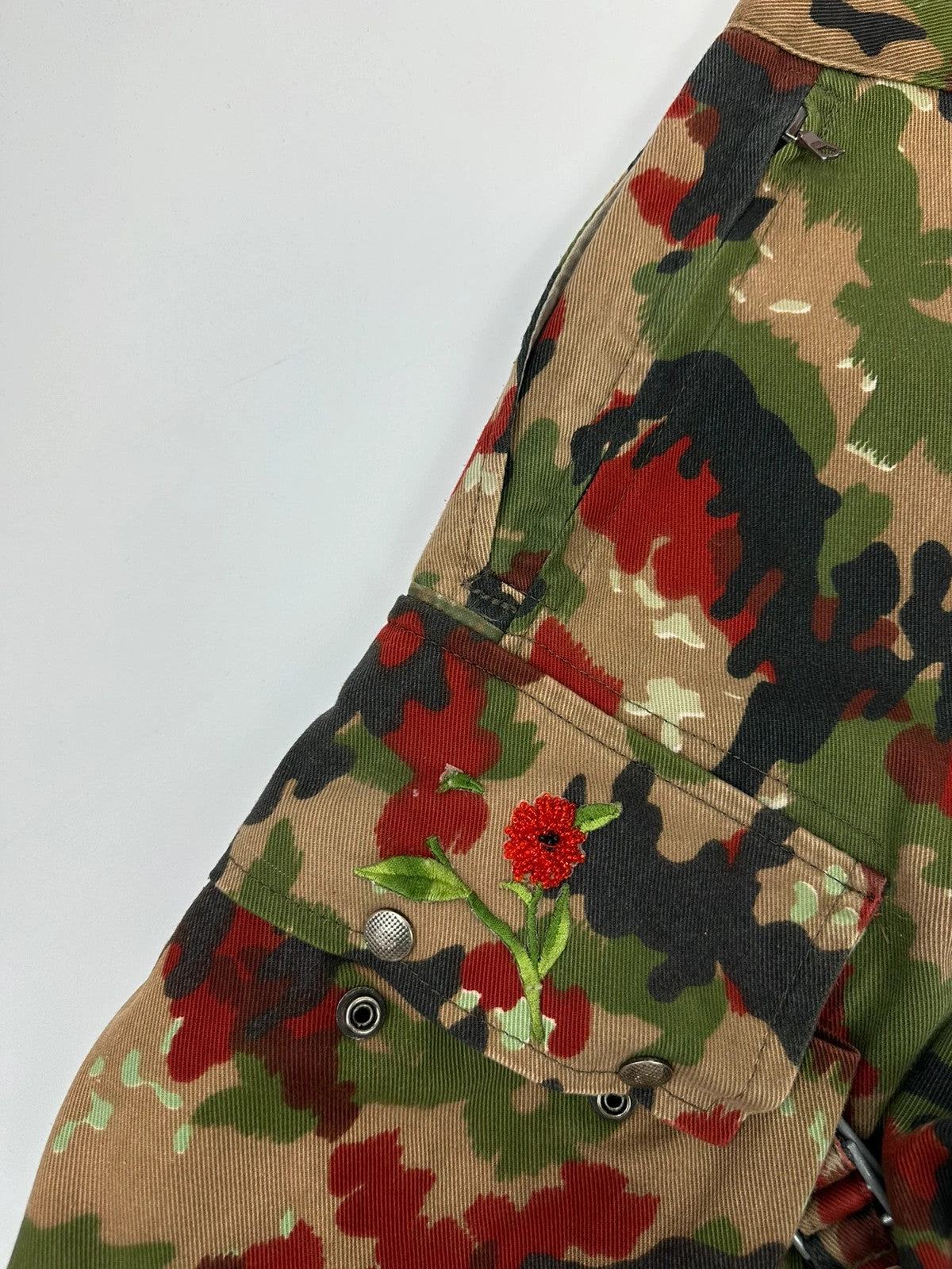 Dolce & Gabbana green camo wide-leg trousers with reworked straps and military pattern.
