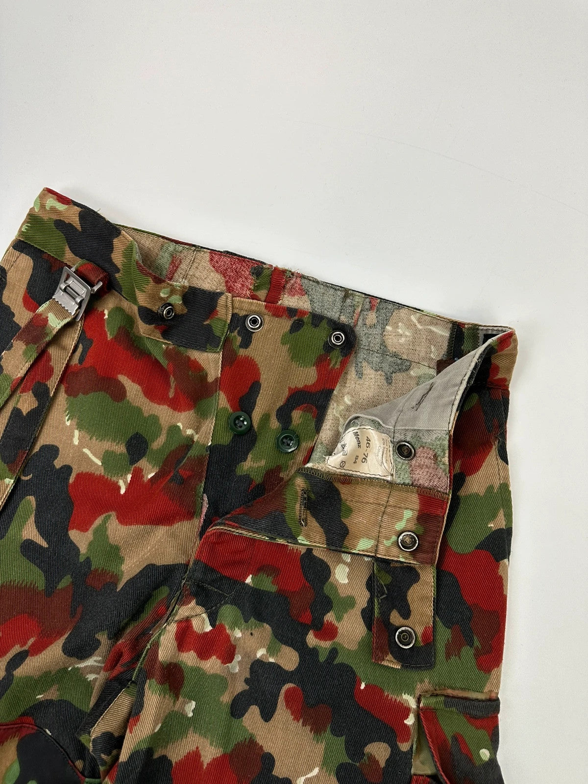 Dolce & Gabbana green camo wide-leg trousers with reworked straps and military pattern.