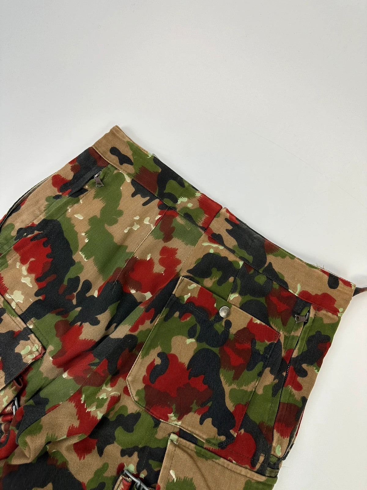 Dolce & Gabbana green camo wide-leg trousers with reworked straps and military pattern.