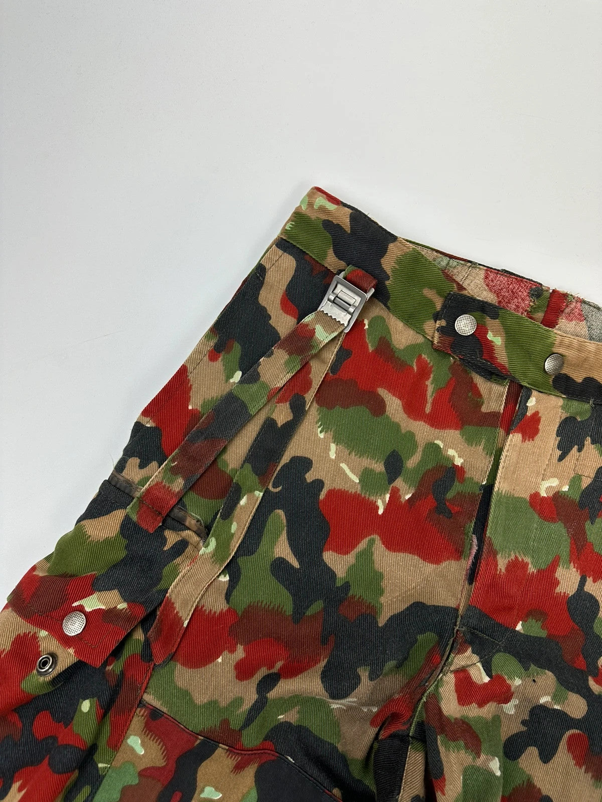 Dolce & Gabbana green camo wide-leg trousers with reworked straps and military pattern.