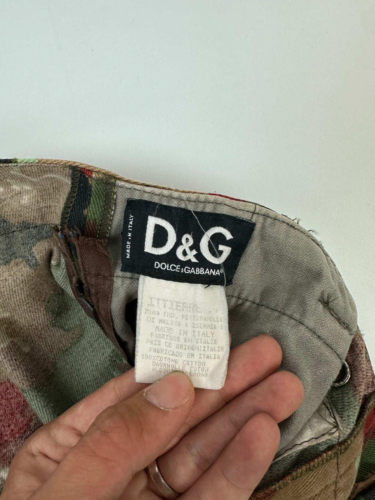 Dolce & Gabbana green camo wide-leg trousers with reworked straps and military pattern.