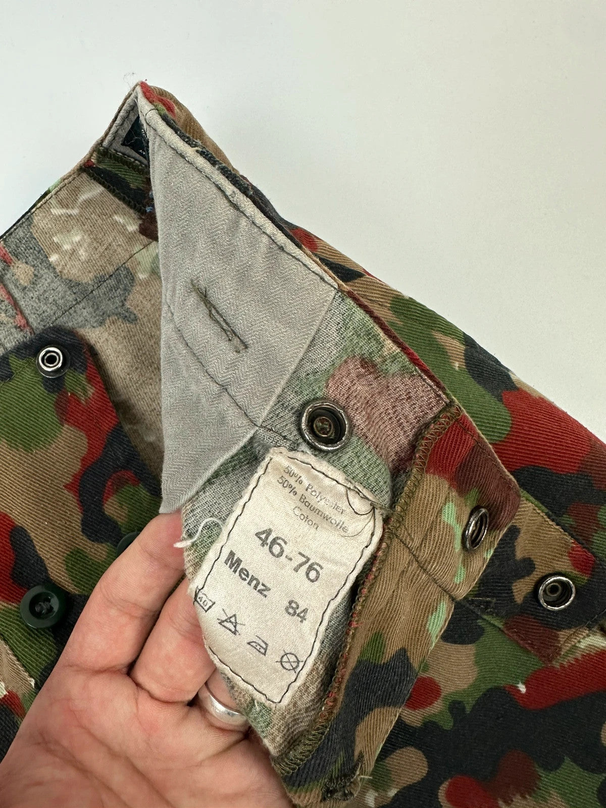 Dolce & Gabbana green camo wide-leg trousers with reworked straps and military pattern.