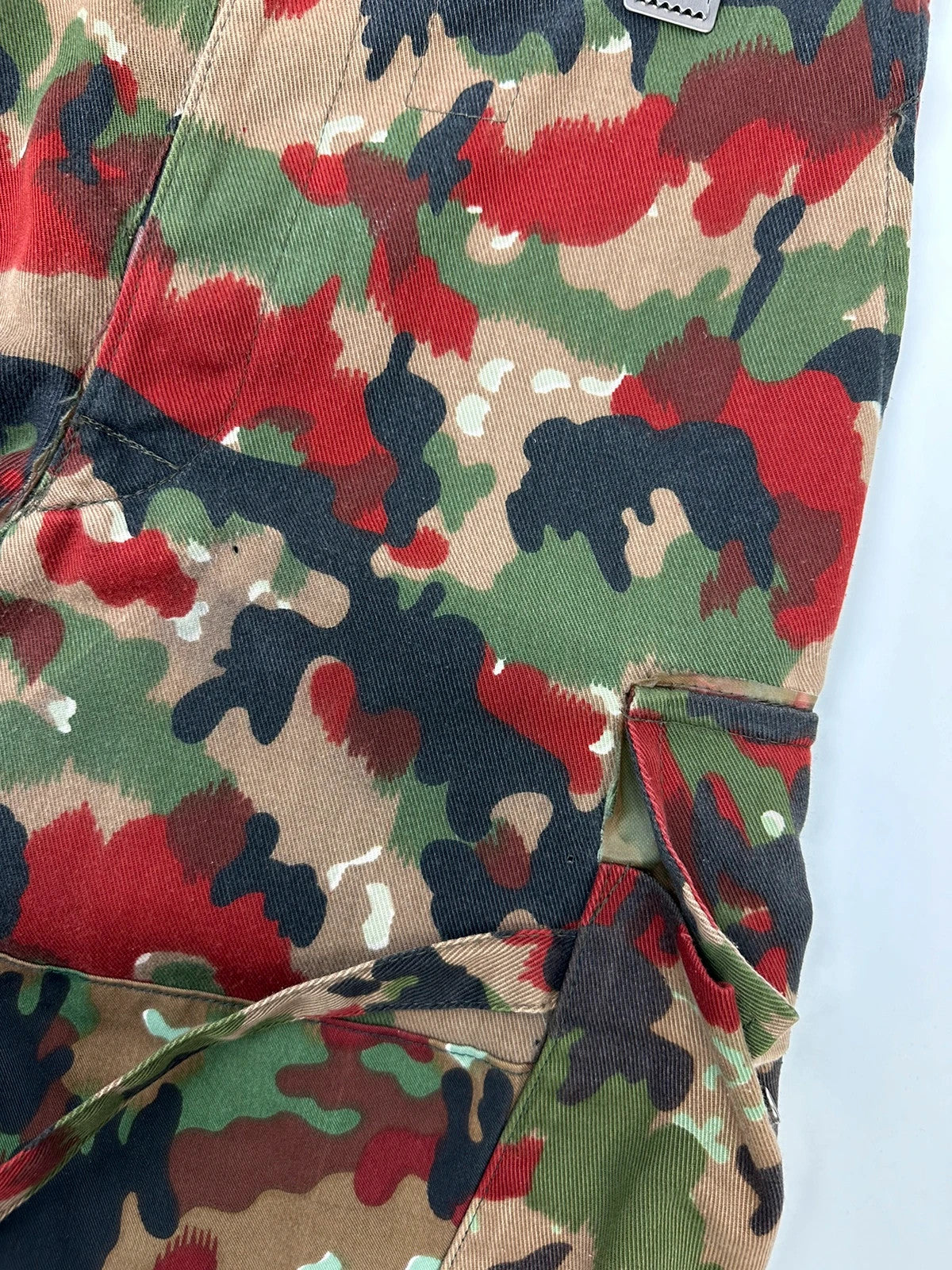 Dolce & Gabbana green camo wide-leg trousers with reworked straps and military pattern.