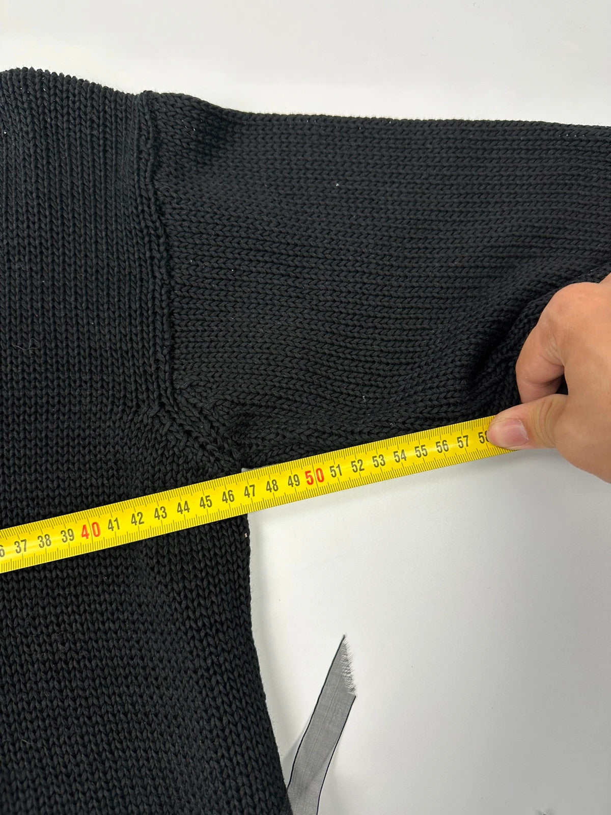 Jean-Paul Gaultier black knit cardigan with unique texture and minimalist design.