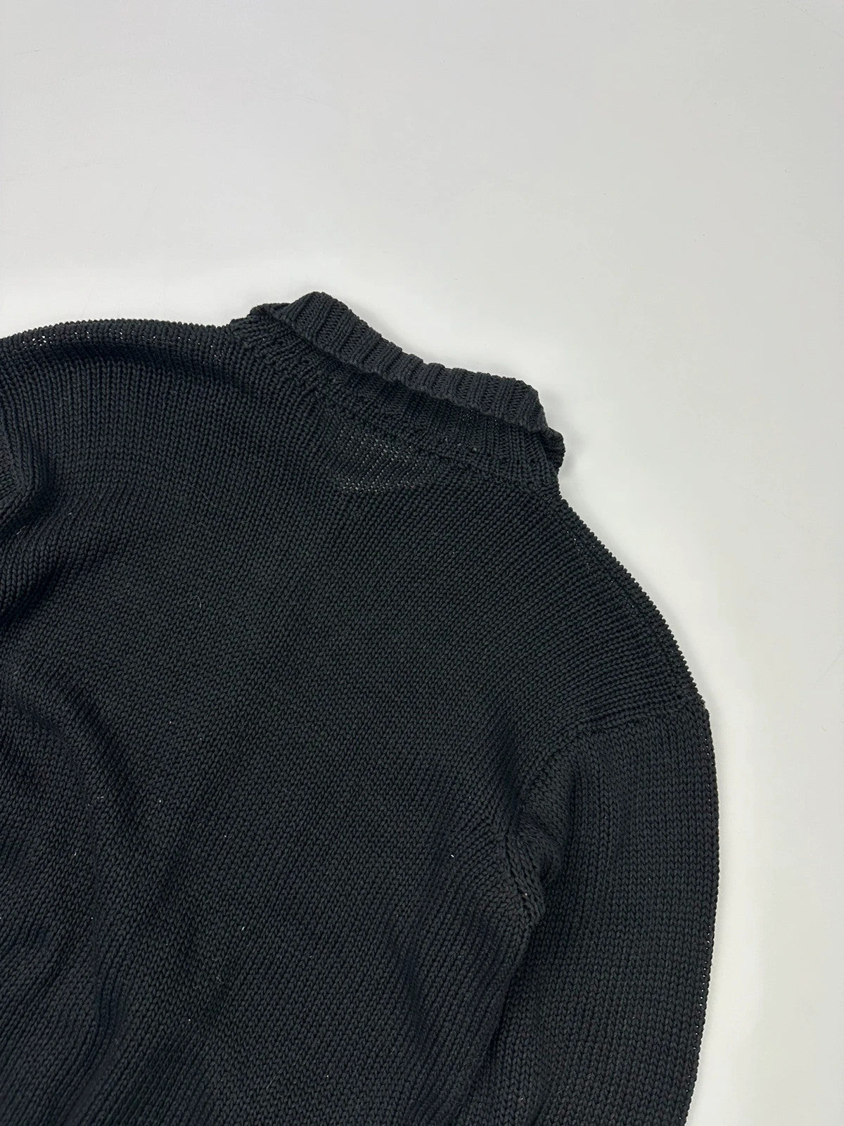 Jean-Paul Gaultier black knit cardigan with unique texture and minimalist design.