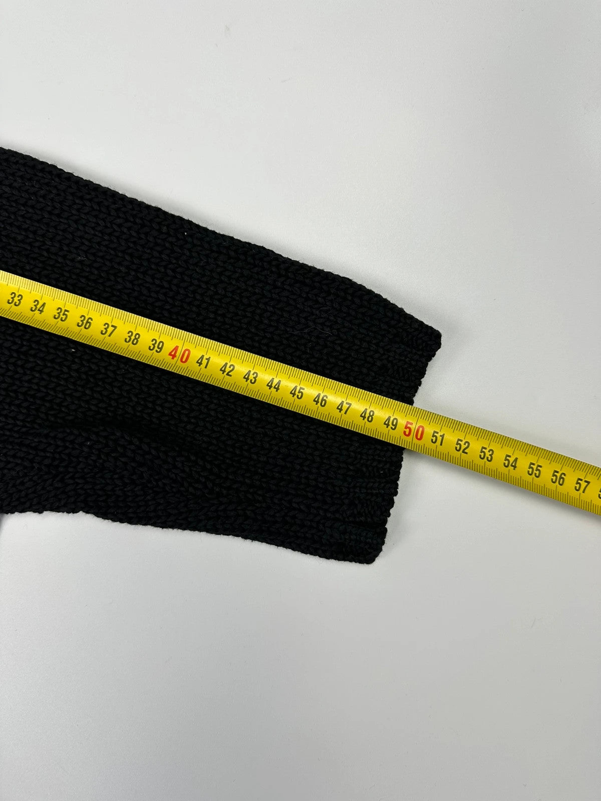 Jean-Paul Gaultier black knit cardigan with unique texture and minimalist design.