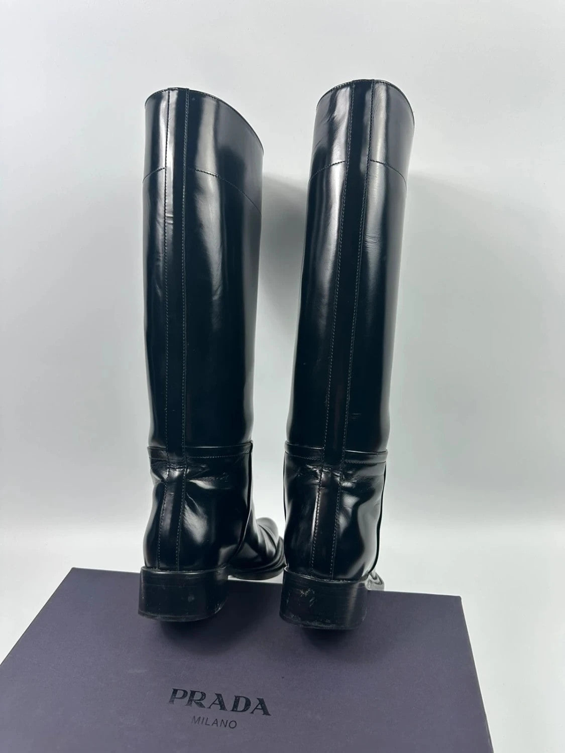 Prada black patent leather pointy toe boots with logo detail and original dustbag.