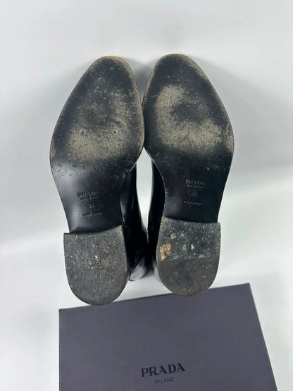 Prada black patent leather pointy toe boots with logo detail and original dustbag.