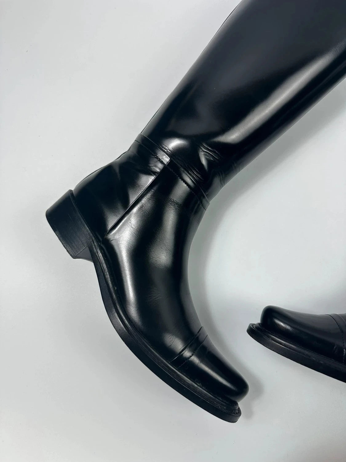 Prada black patent leather pointy toe boots with logo detail and original dustbag.