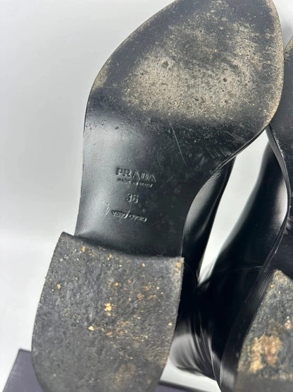 Prada black patent leather pointy toe boots with logo detail and original dustbag.