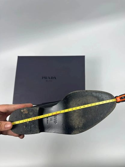 Prada black patent leather pointy toe boots with logo detail and original dustbag.