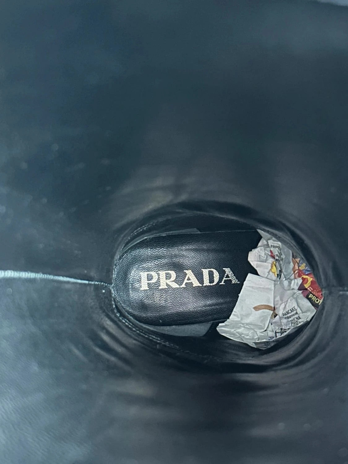 Prada black patent leather pointy toe boots with logo detail and original dustbag.