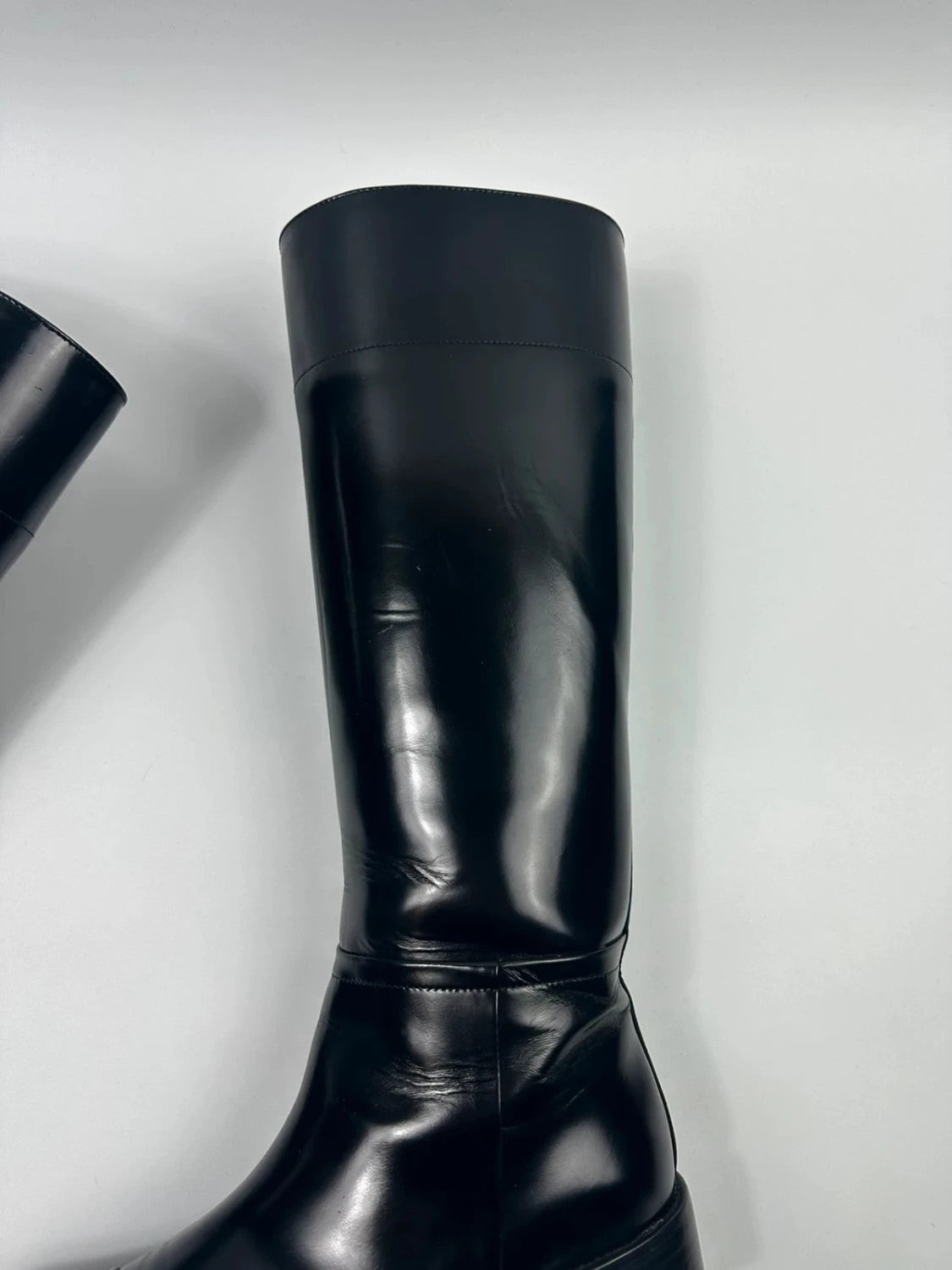 Prada black patent leather pointy toe boots with logo detail and original dustbag.