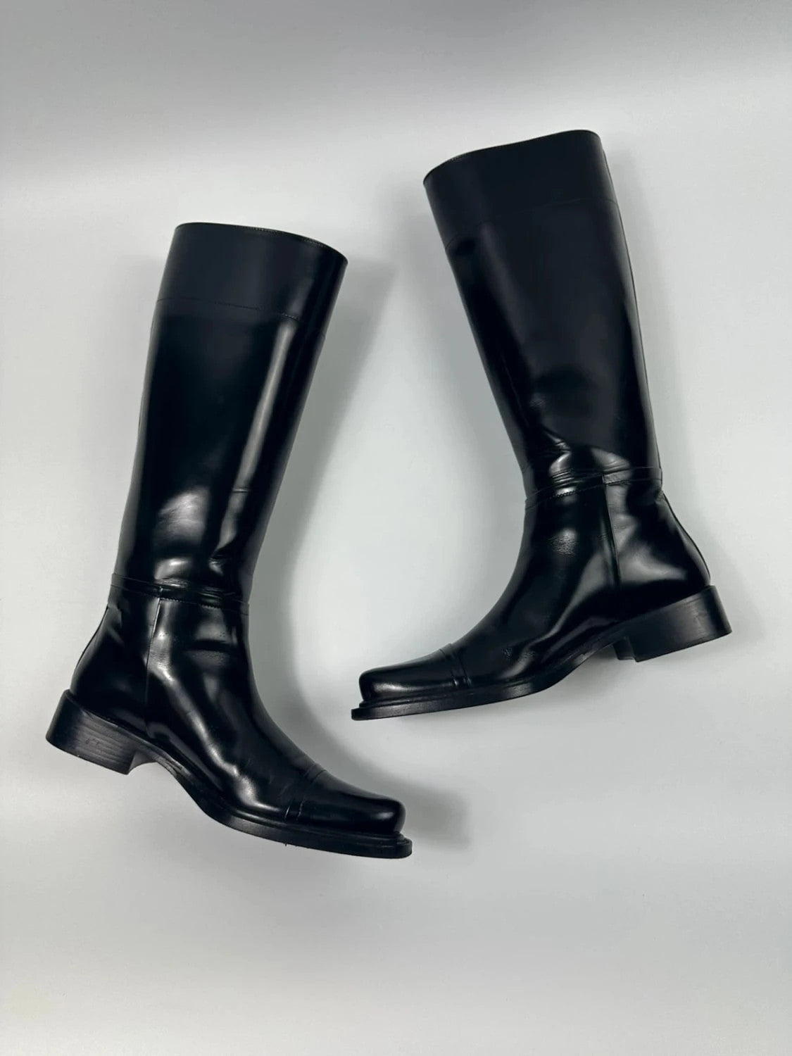 Prada black patent leather pointy toe boots with logo detail and original dustbag.