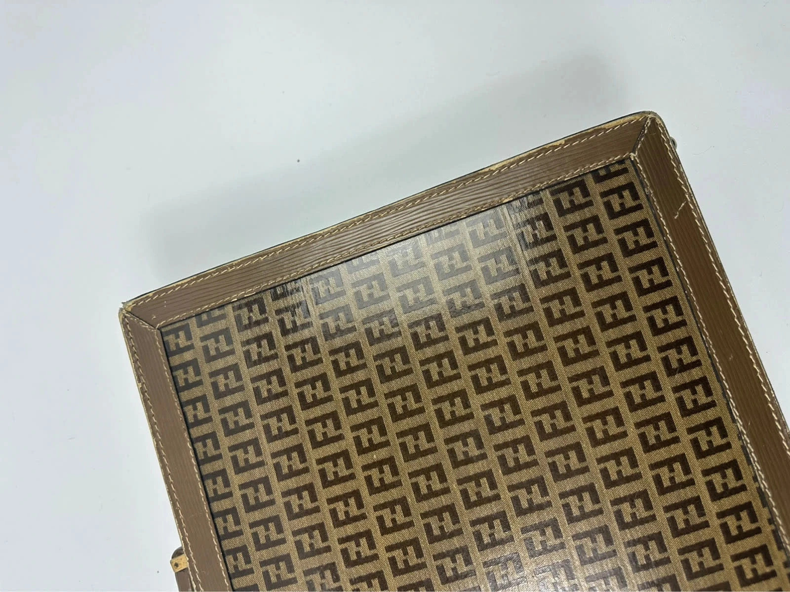 Fendi beige and brown briefcase with 70s FF monogram pattern and leather material.