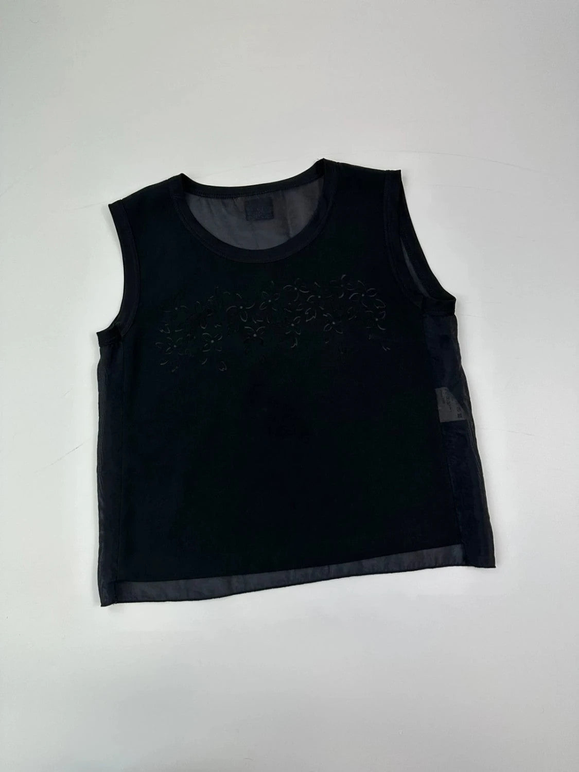 Marithé Francois Girbaud black tank top with floral laser cut details and sheer back.