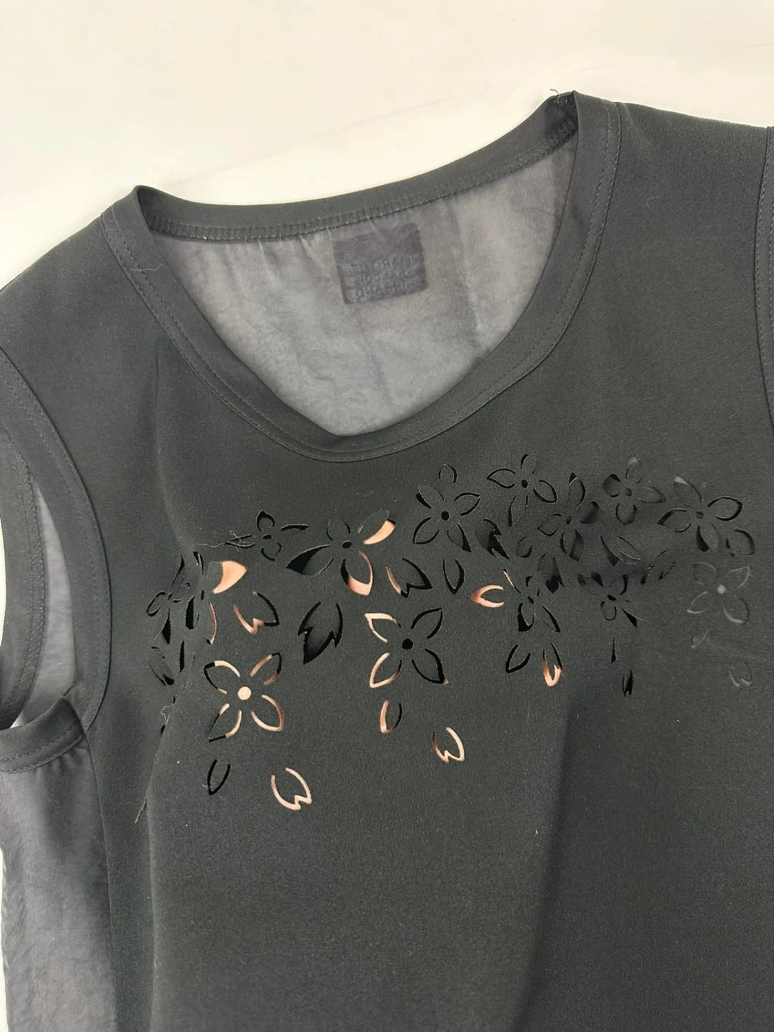 Marithé Francois Girbaud black tank top with floral laser cut details and sheer back.