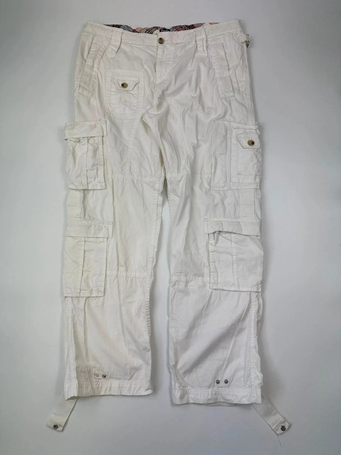 Dolce & Gabbana white wide-leg trousers with multiple pockets and adjustable drawstring waist.