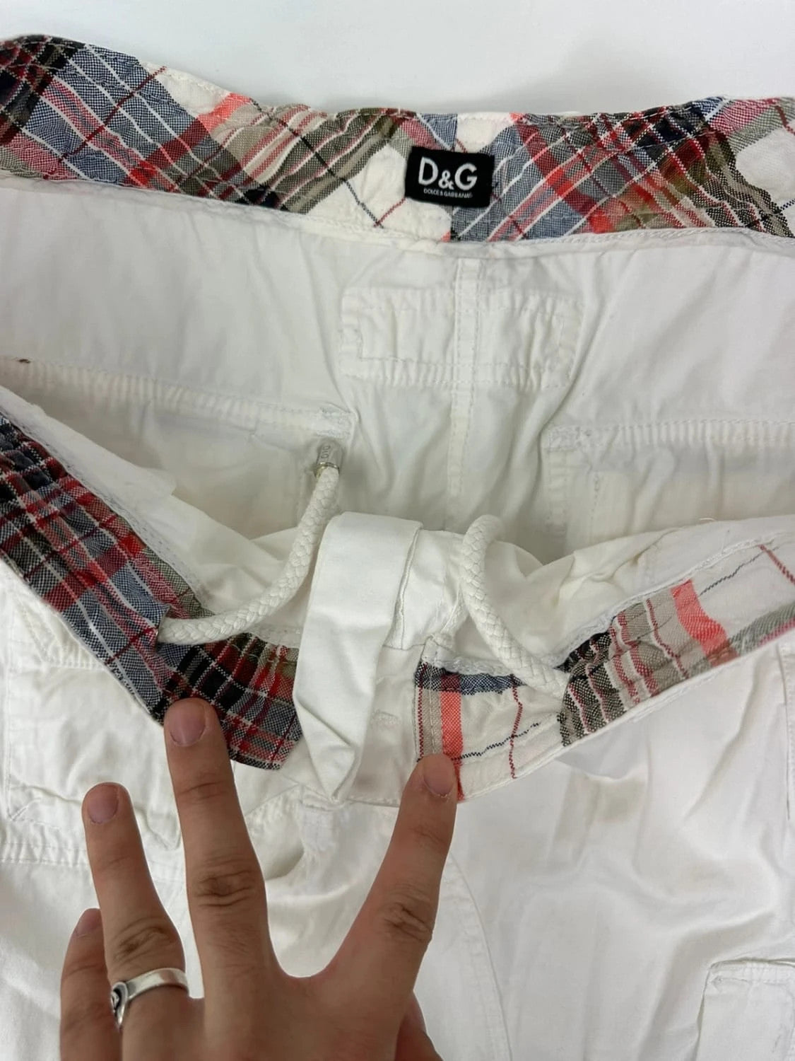 Dolce & Gabbana white wide-leg trousers with multiple pockets and adjustable drawstring waist.
