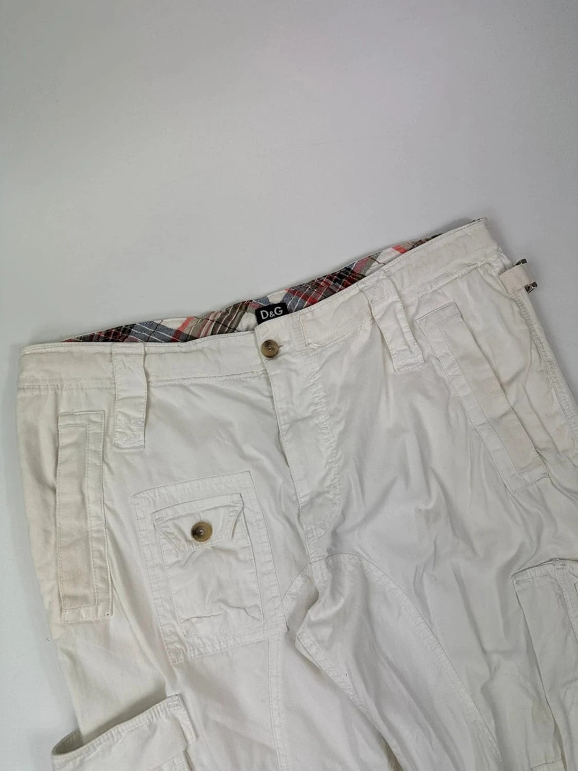 Dolce & Gabbana white wide-leg trousers with multiple pockets and adjustable drawstring waist.