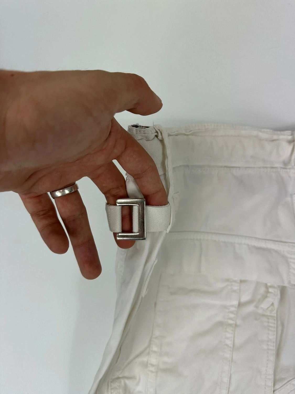 Dolce & Gabbana white wide-leg trousers with multiple pockets and adjustable drawstring waist.
