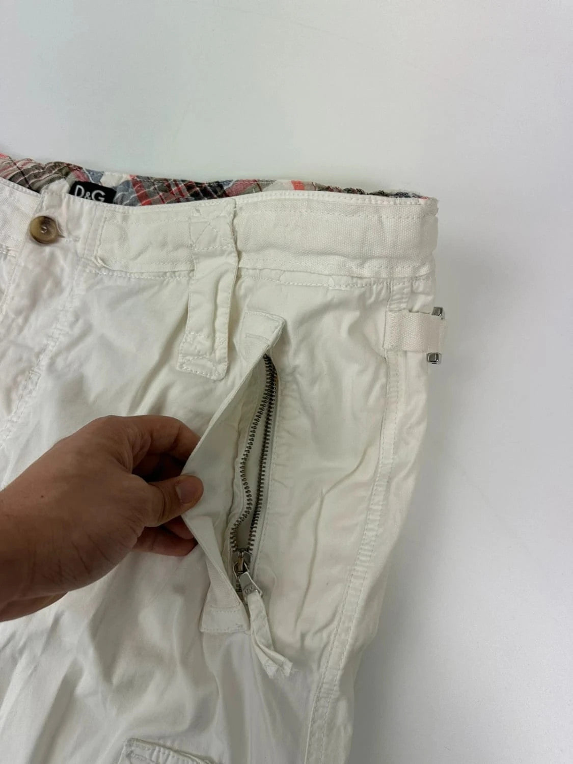 Dolce & Gabbana white wide-leg trousers with multiple pockets and adjustable drawstring waist.