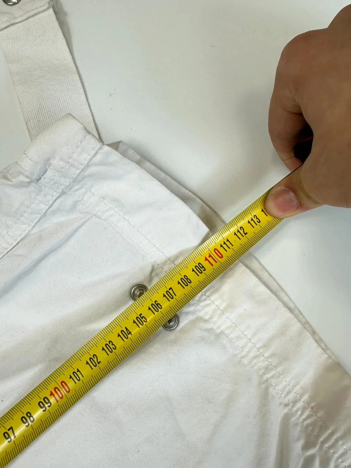 Dolce & Gabbana white wide-leg trousers with multiple pockets and adjustable drawstring waist.