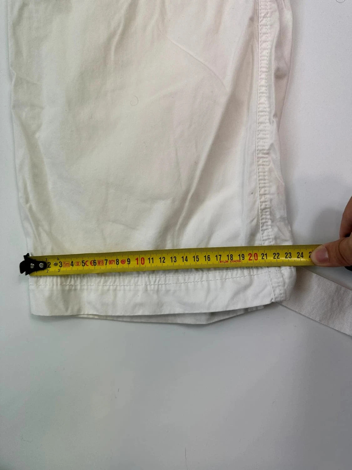 Dolce & Gabbana white wide-leg trousers with multiple pockets and adjustable drawstring waist.