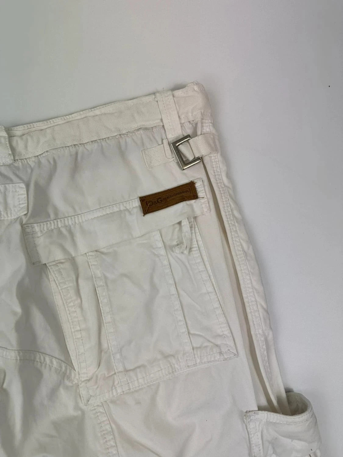 Dolce & Gabbana white wide-leg trousers with multiple pockets and adjustable drawstring waist.