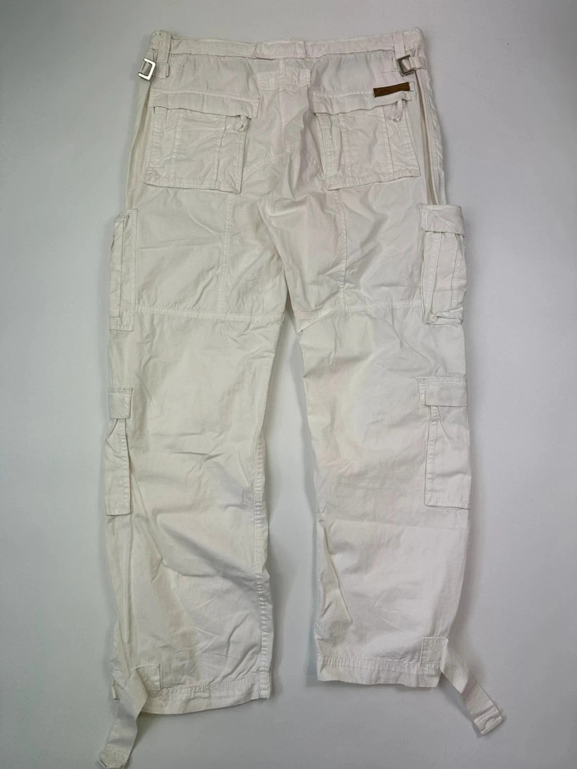 Dolce & Gabbana white wide-leg trousers with multiple pockets and adjustable drawstring waist.