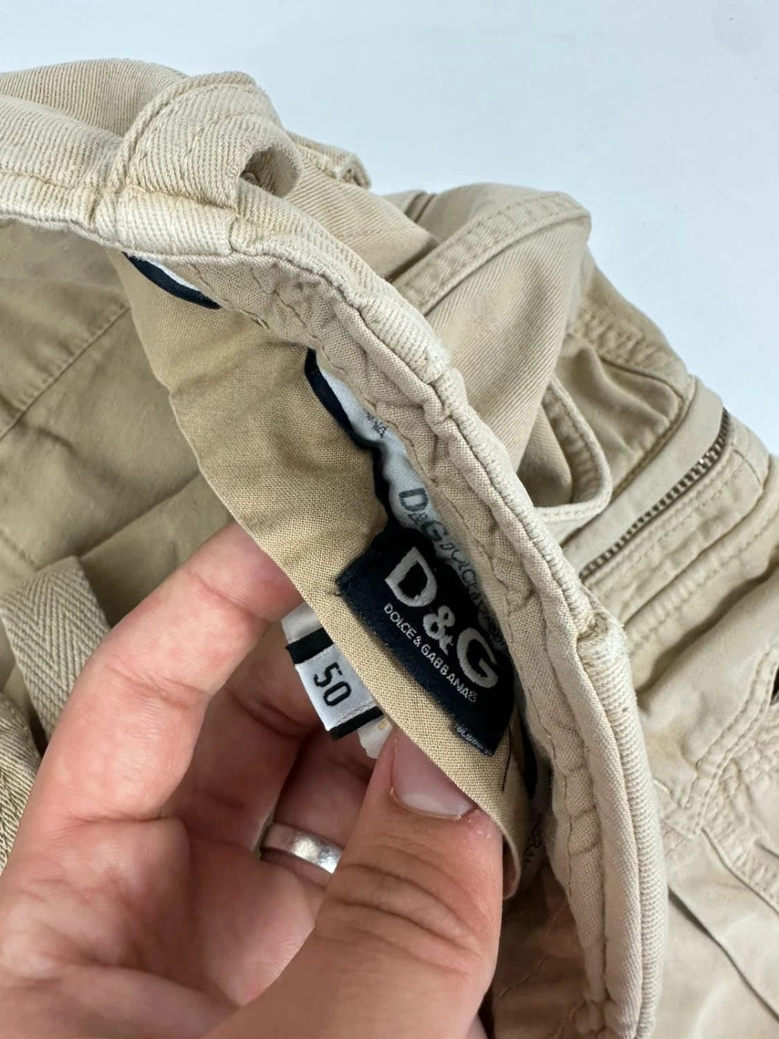 Dolce & Gabbana beige wide-leg trousers with logo on back pocket and adjustable drawstring.