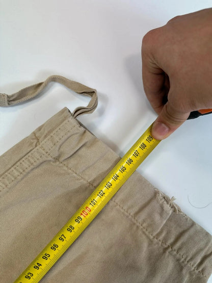 Dolce & Gabbana beige wide-leg trousers with logo on back pocket and adjustable drawstring.