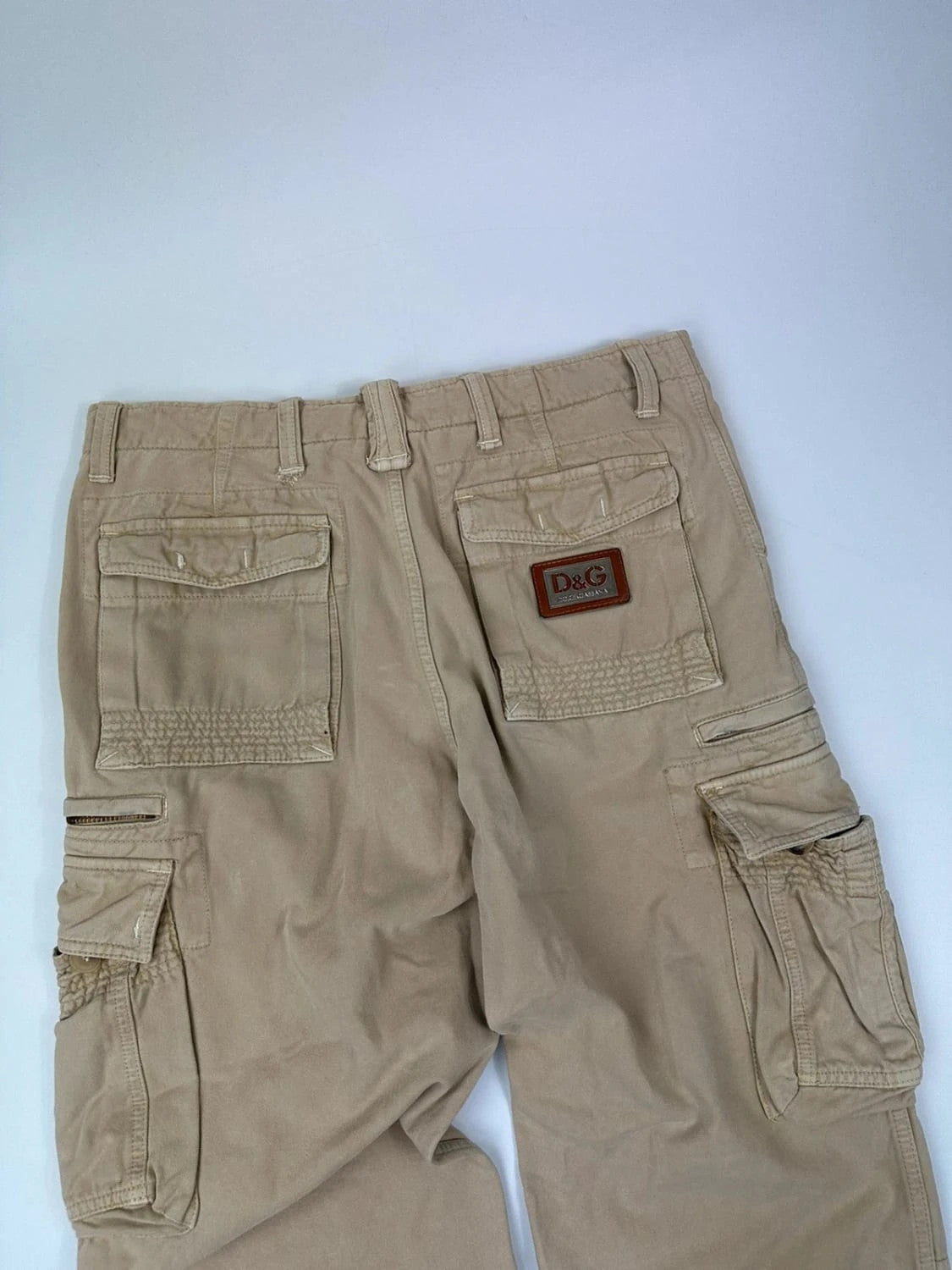 Dolce & Gabbana beige wide-leg trousers with logo on back pocket and adjustable drawstring.