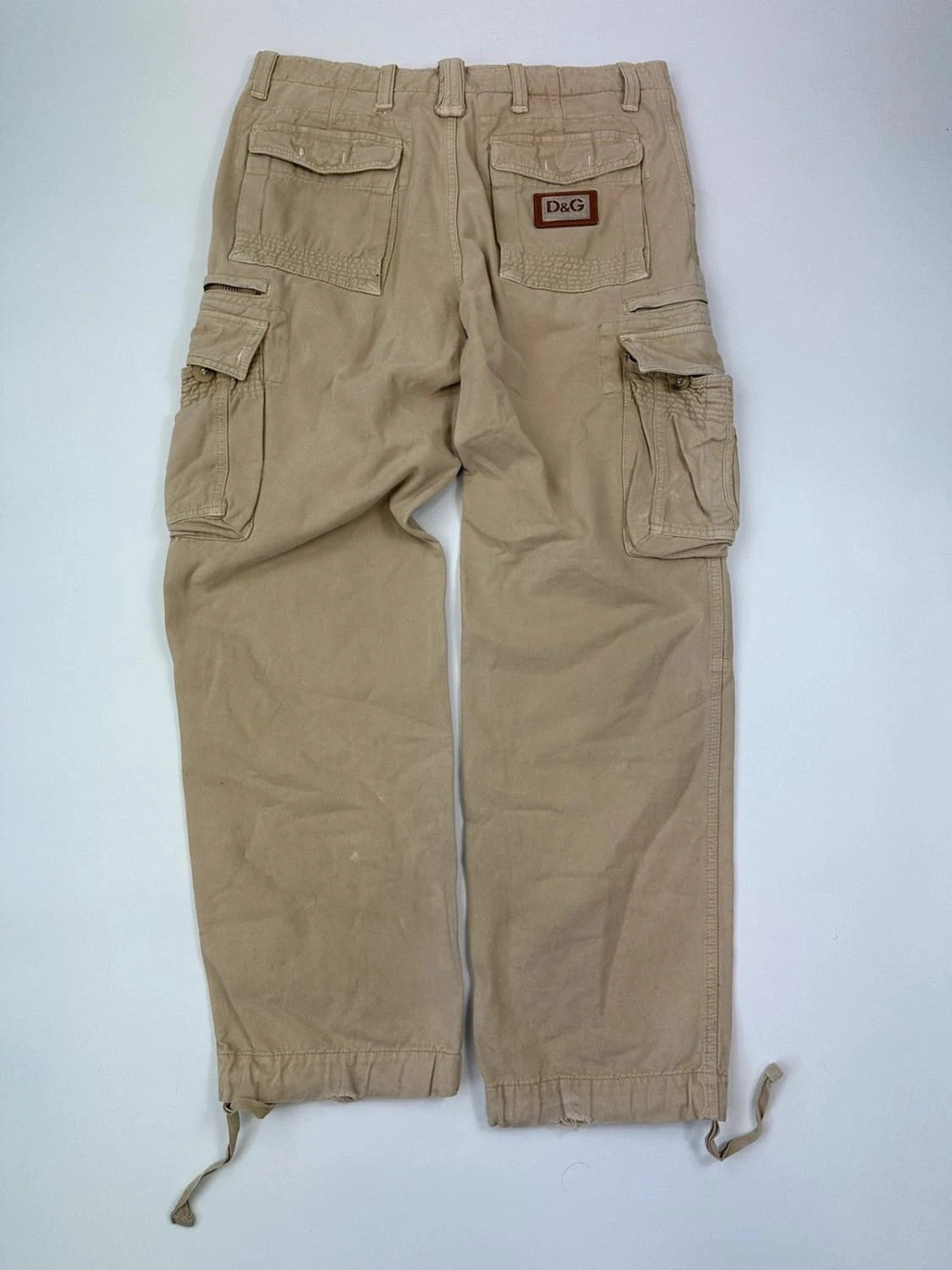 Dolce & Gabbana beige wide-leg trousers with logo on back pocket and adjustable drawstring.