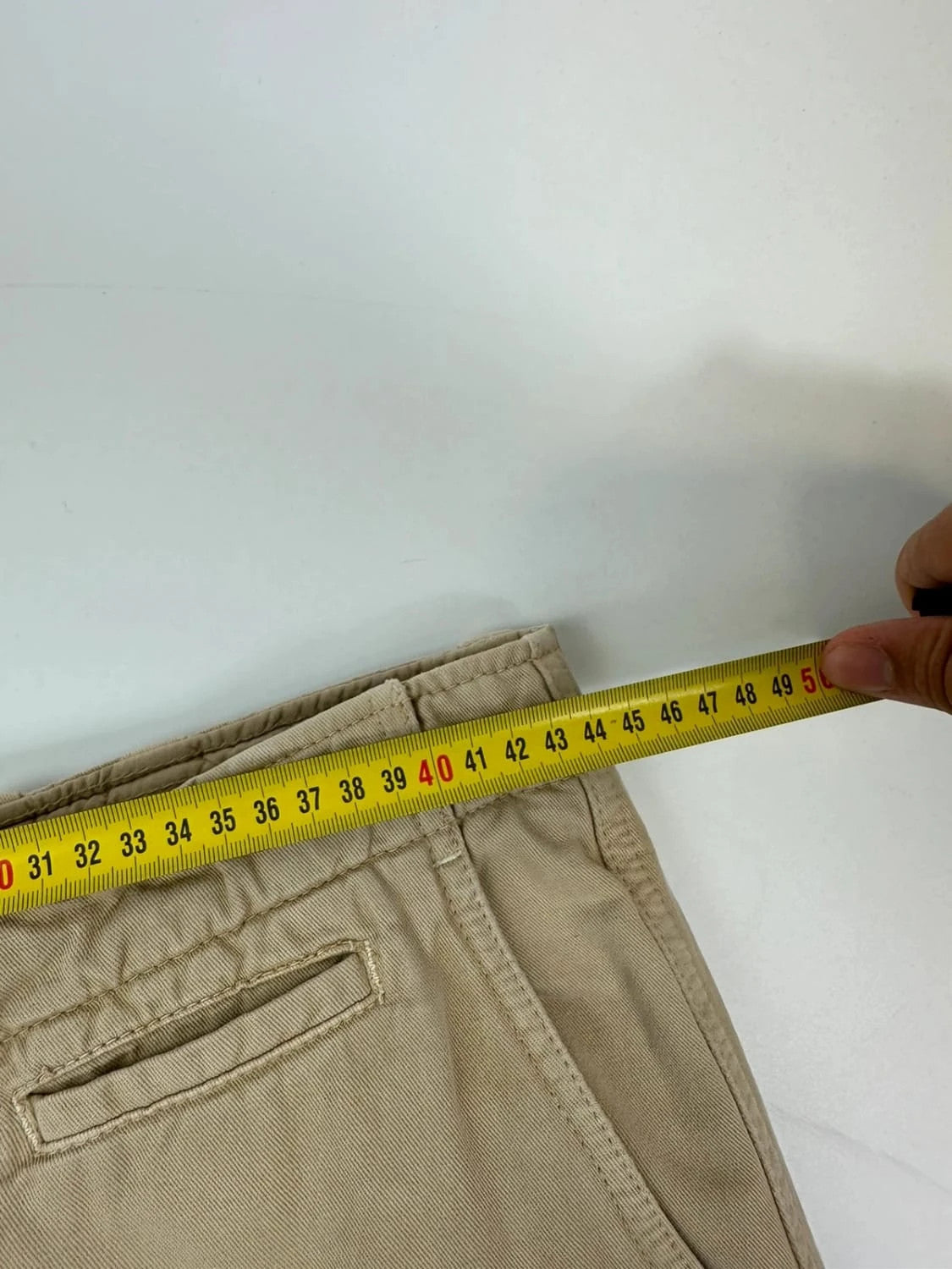 Dolce & Gabbana beige wide-leg trousers with logo on back pocket and adjustable drawstring.