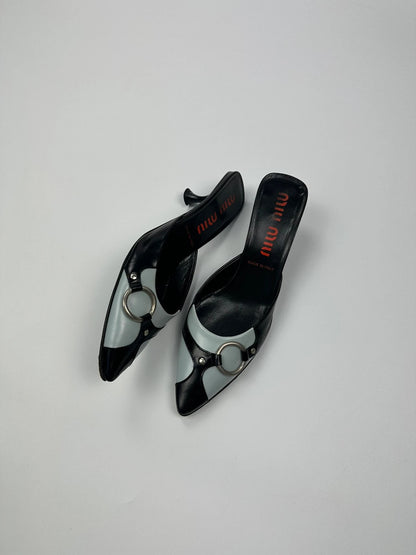Miu Miu black and blue patent leather pumps with pointy toe and logo detail.