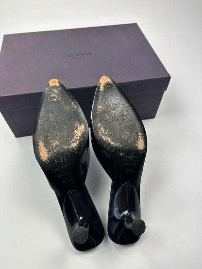 Miu Miu black and blue patent leather pumps with pointy toe and logo detail.