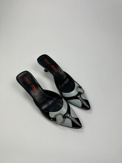 Miu Miu black and blue patent leather pumps with pointy toe and logo detail.