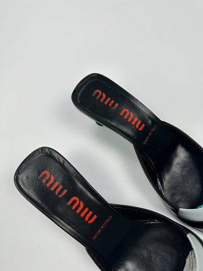 Miu Miu black and blue patent leather pumps with pointy toe and logo detail.