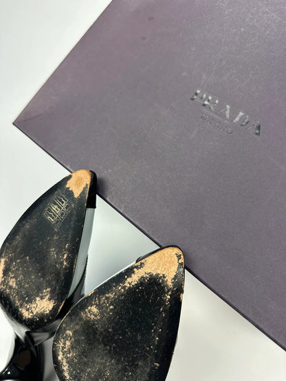 Miu Miu black and blue patent leather pumps with pointy toe and logo detail.