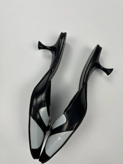 Miu Miu black and blue patent leather pumps with pointy toe and logo detail.