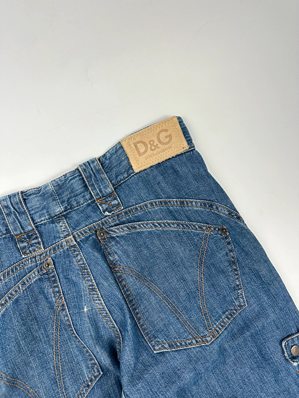 Dolce & Gabbana blue straight jeans with cargo pockets and mesh detailing from SS03 collection.
