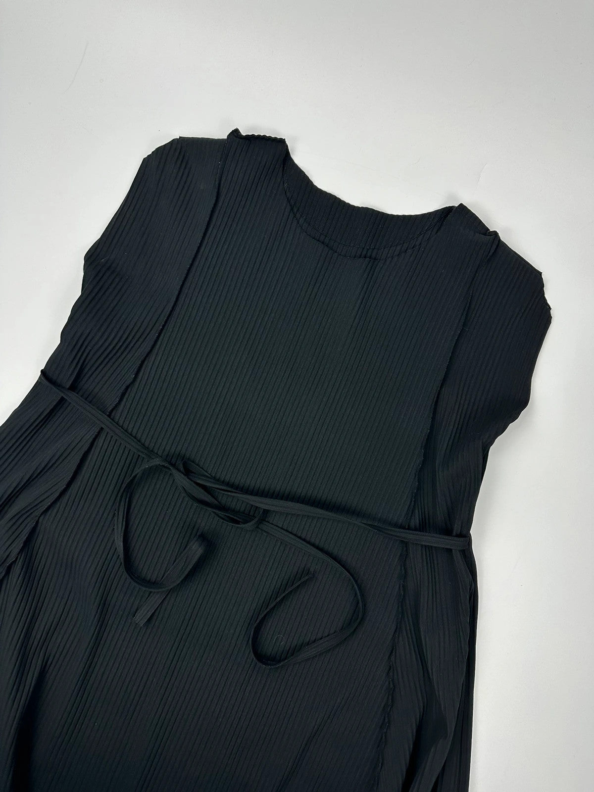 Issey Miyake black linen maxi dress with pleated design and unique string details.