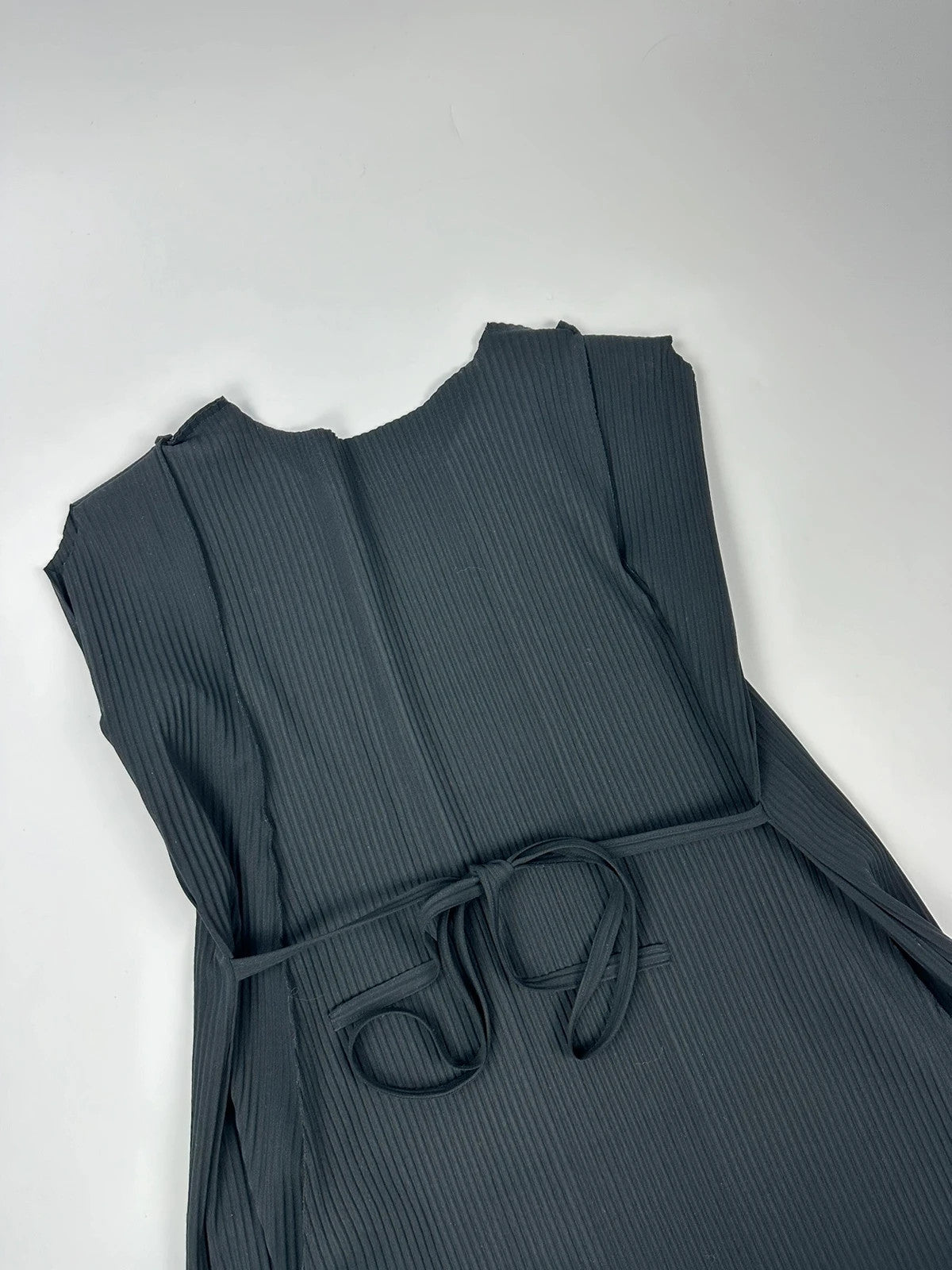 Issey Miyake black linen maxi dress with pleated design and unique string details.