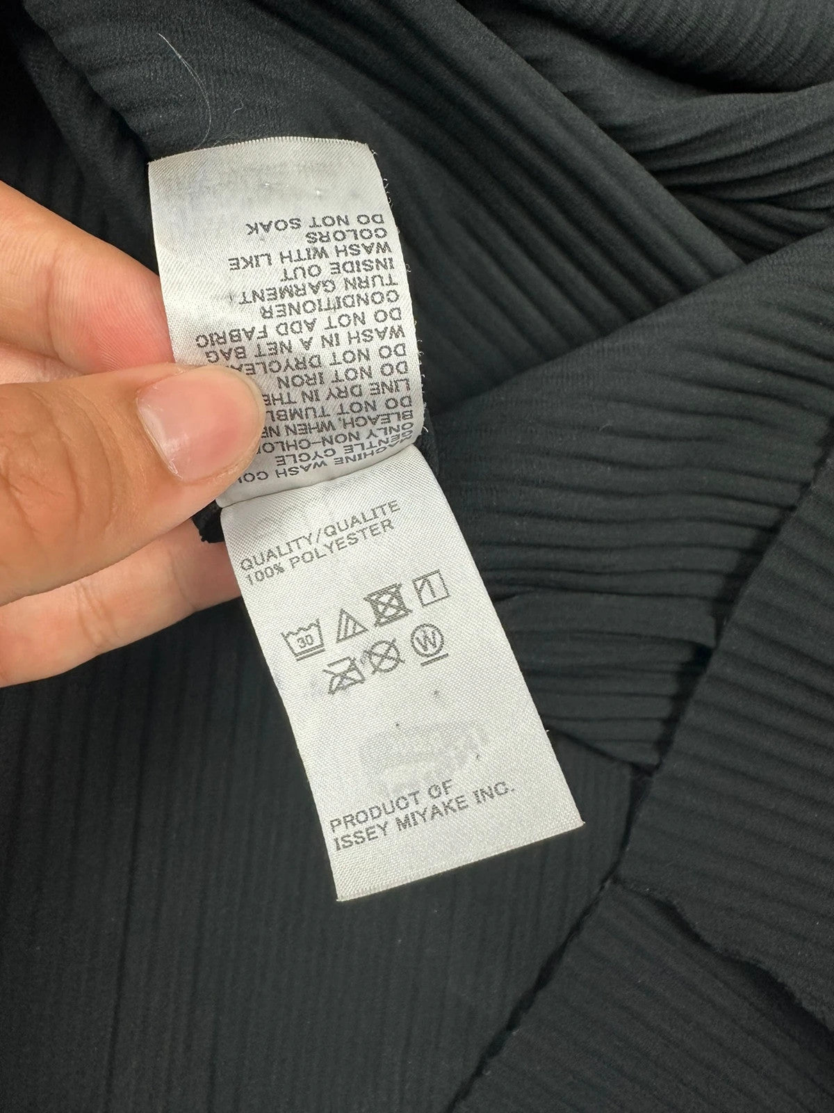 Issey Miyake black linen maxi dress with pleated design and unique string details.