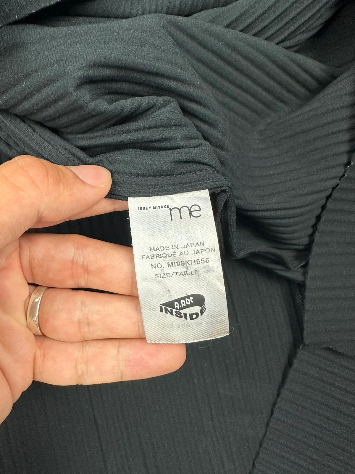 Issey Miyake black linen maxi dress with pleated design and unique string details.